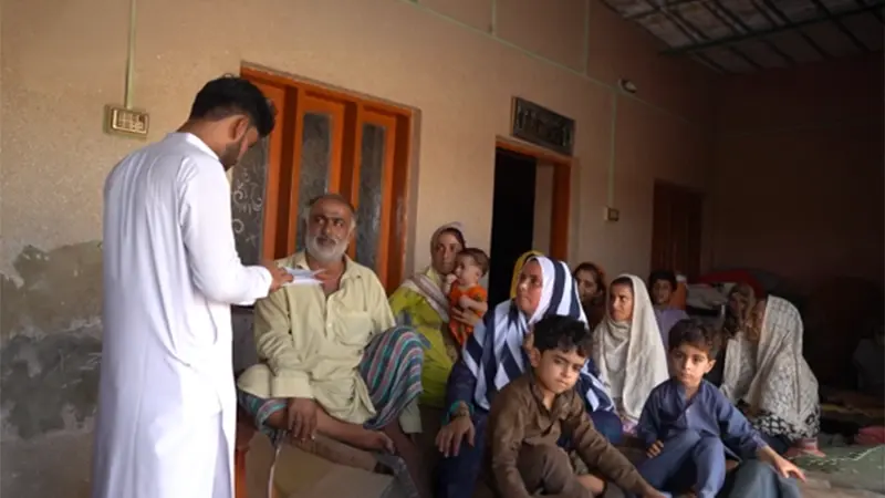 SHINE Humanity health worker visiting a rural family at home to share health guidance