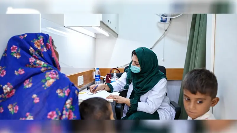 SHINE Humanity doctor consulting a mother and child at a rural primary healthcare clinic