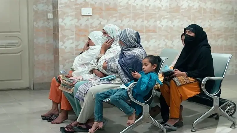 Pakistani women and a child waiting at a healthcare clinic, reflecting communities affected by thalassemia in Pakistan